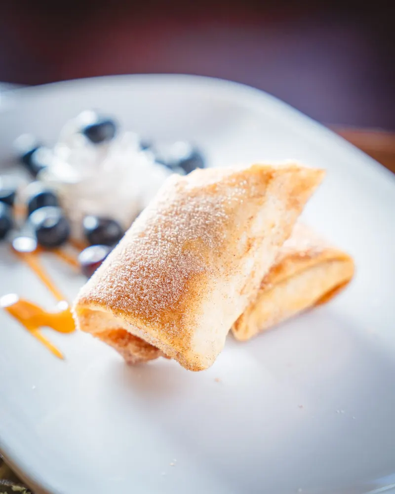 Niño envuelto with blueberries and whipped cream